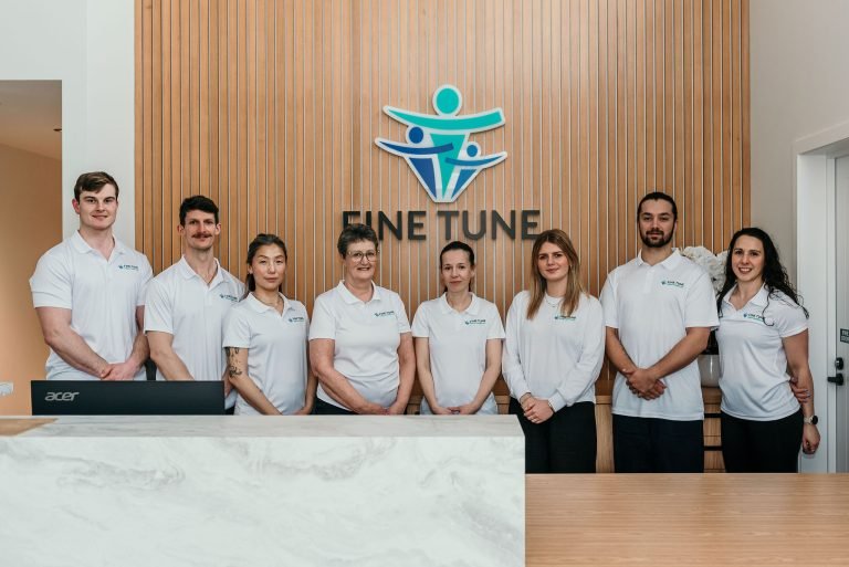 Fine Tune Allied Healthcare team standing together at the clinic reception.